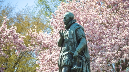  Statue of Willie the Silent surrounded by pink magnolia blossoms on Voorhees Mall in New Brunswick on the College Avenue campus.