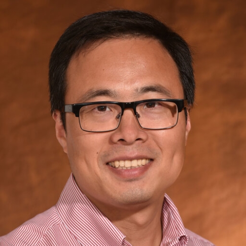 smiling Asian man with short black hair and eyeglasses