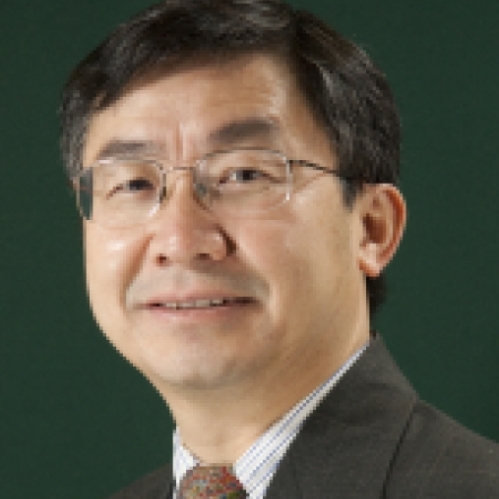 headshot of Asian male with eyeglasses wearing a dark suit and tie