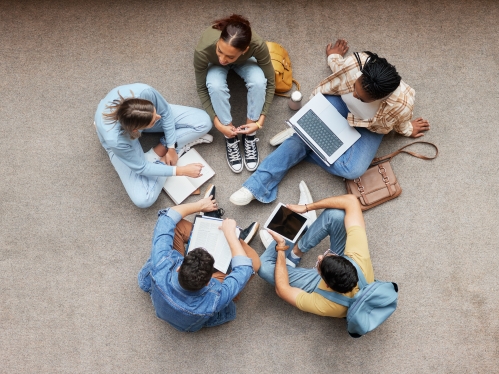 Study, laptop and group of students on floor in project, research or planning, brainstorming and teamwork. Notebook, education and top of university student, friends or people collaboration in school