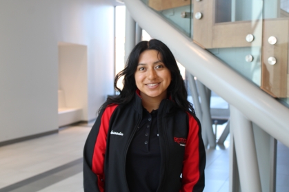 Female student with long black hair wearing a black and red Rutgers School of Engineering Ambassador jacket.