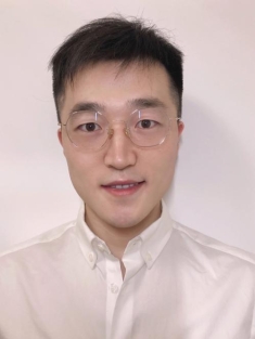 Headshot of Asian male with short black hair wearing eyeglasses.